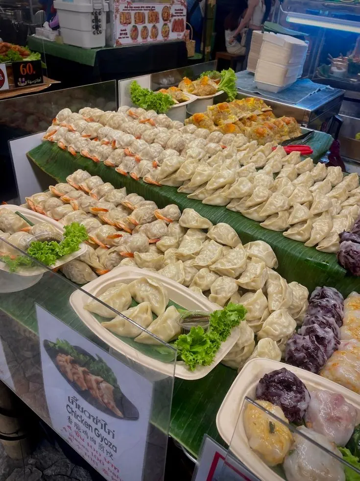 Rows of fresh dumplings laid out on a street-market counter